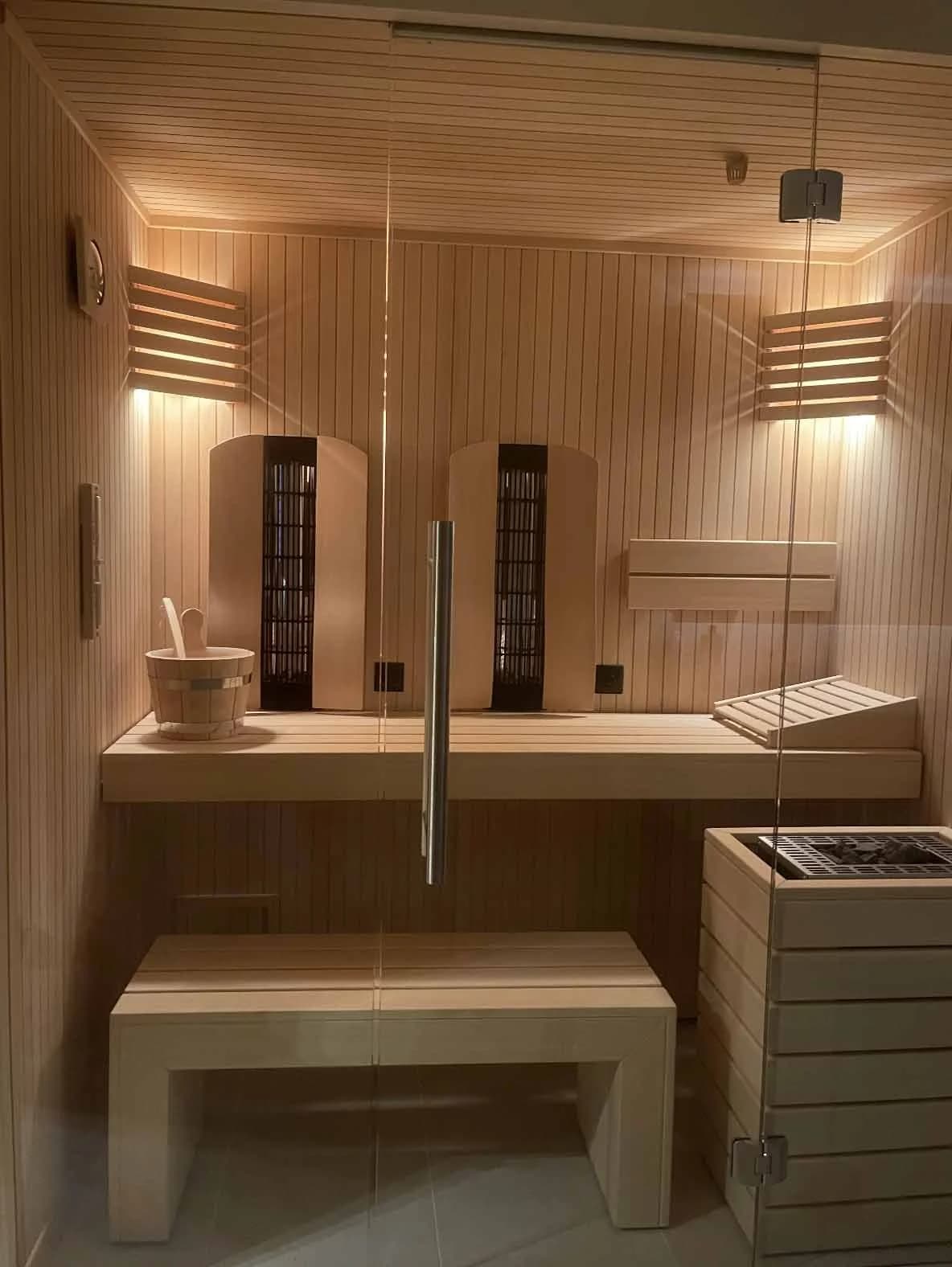 Interior of a home sauna with timber benching and warm lighting